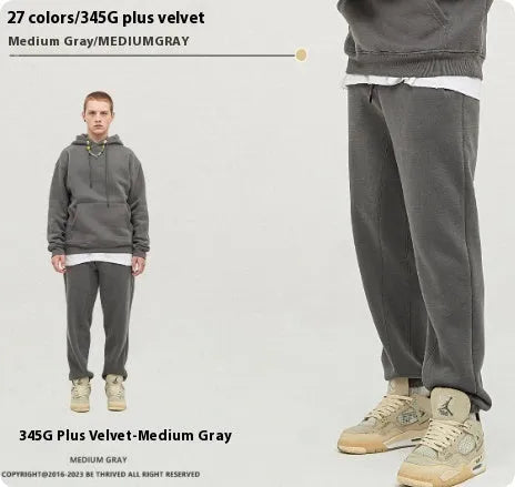 Man wearing dark brown velvet sweatpants with an ankle band and elastic waist.