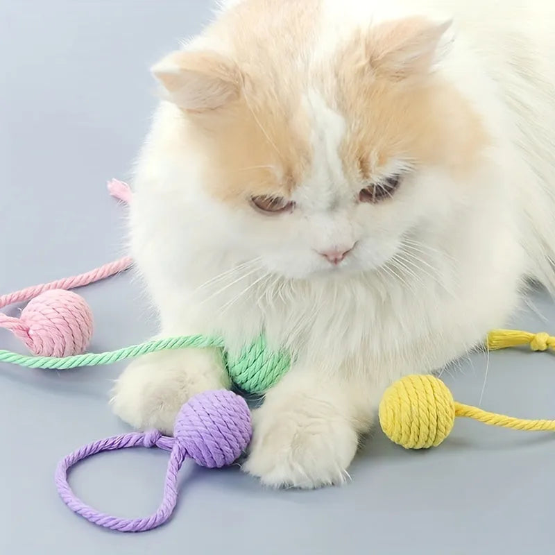 Colourful cat toy ball with rope handle and built-in bell for interactive play