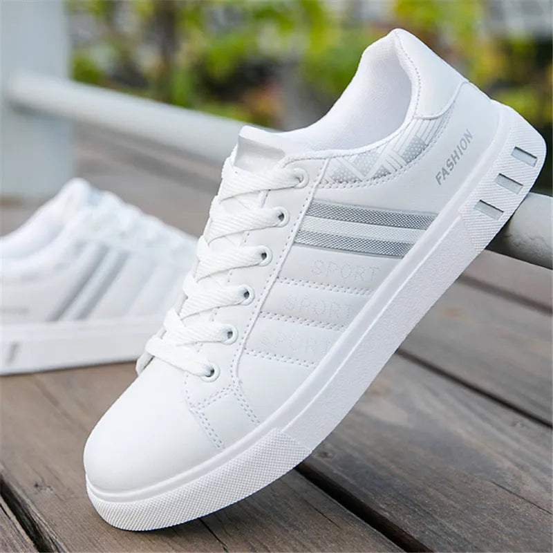 A pair of neutral-coloured sports shoes on a white background, shown in black, grey and white colour options.