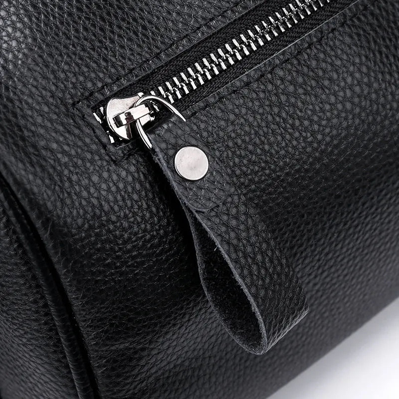 Black genuine leather crossbody bag with adjustable strap and large 24x16x13cm capacity.