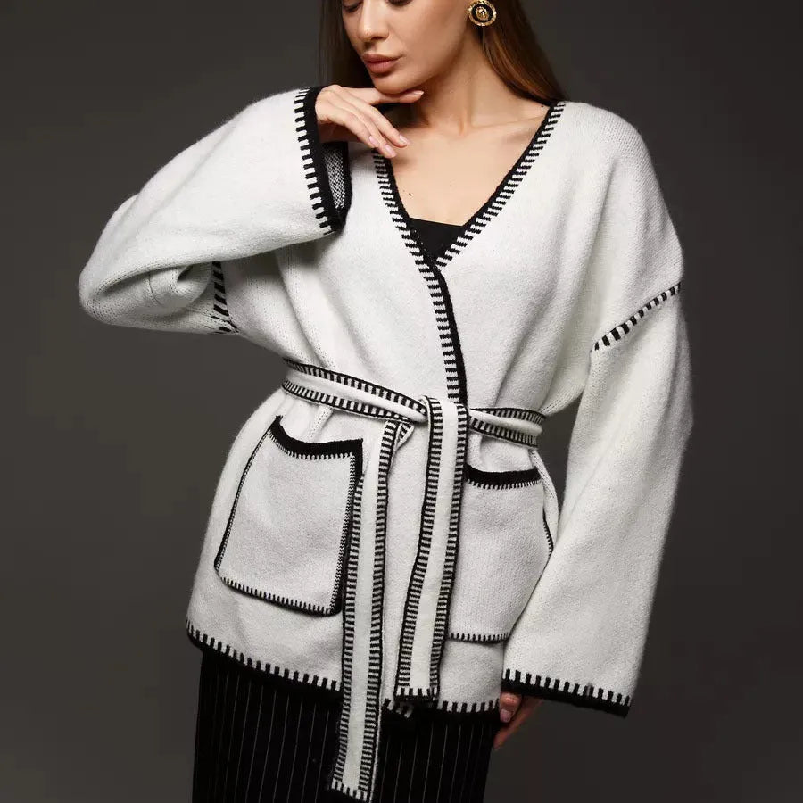 Lace-up front knitted cardigan sweater coat in camel colour, showing loose fit and long sleeves.
