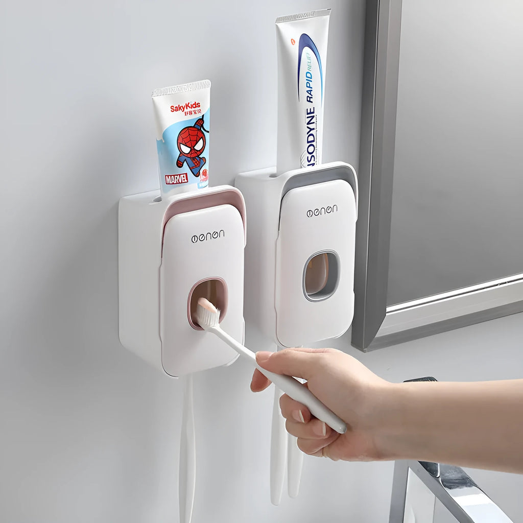 Blue automatic toothpaste dispenser with infrared sensor mounted on a bathroom wall.
