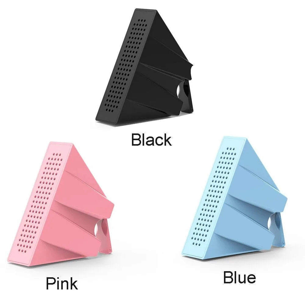 A small, coloured ABS plastic phone amplifier holder on a desktop, holding a mobile phone horizontally.
