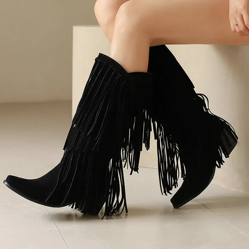 Women's black suede knee-high boots with a chunky heel and tassel decoration.