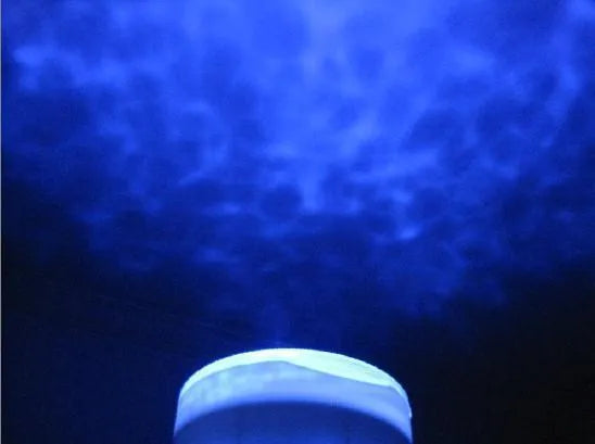 Blue ocean LED projection lamp showing aquatic scene projection on wall with DLP trapezoidal correction technology