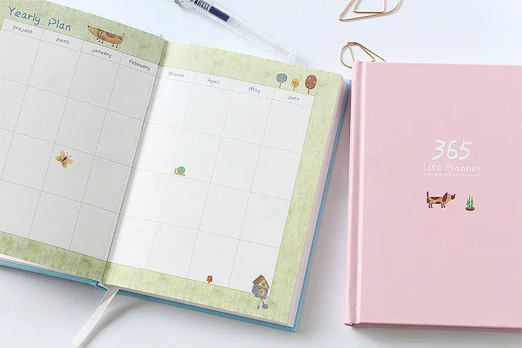 Hardback colour inside notebook planner with 228 pages, open to daily schedule, shown in Dark Green