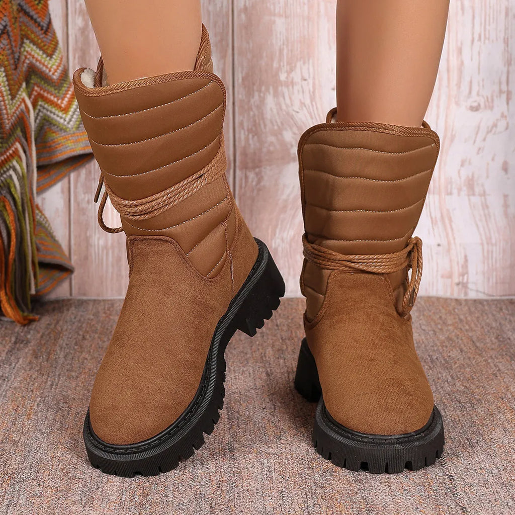 Women's black chunky heel snow boots with lace-up design and fleece lining.