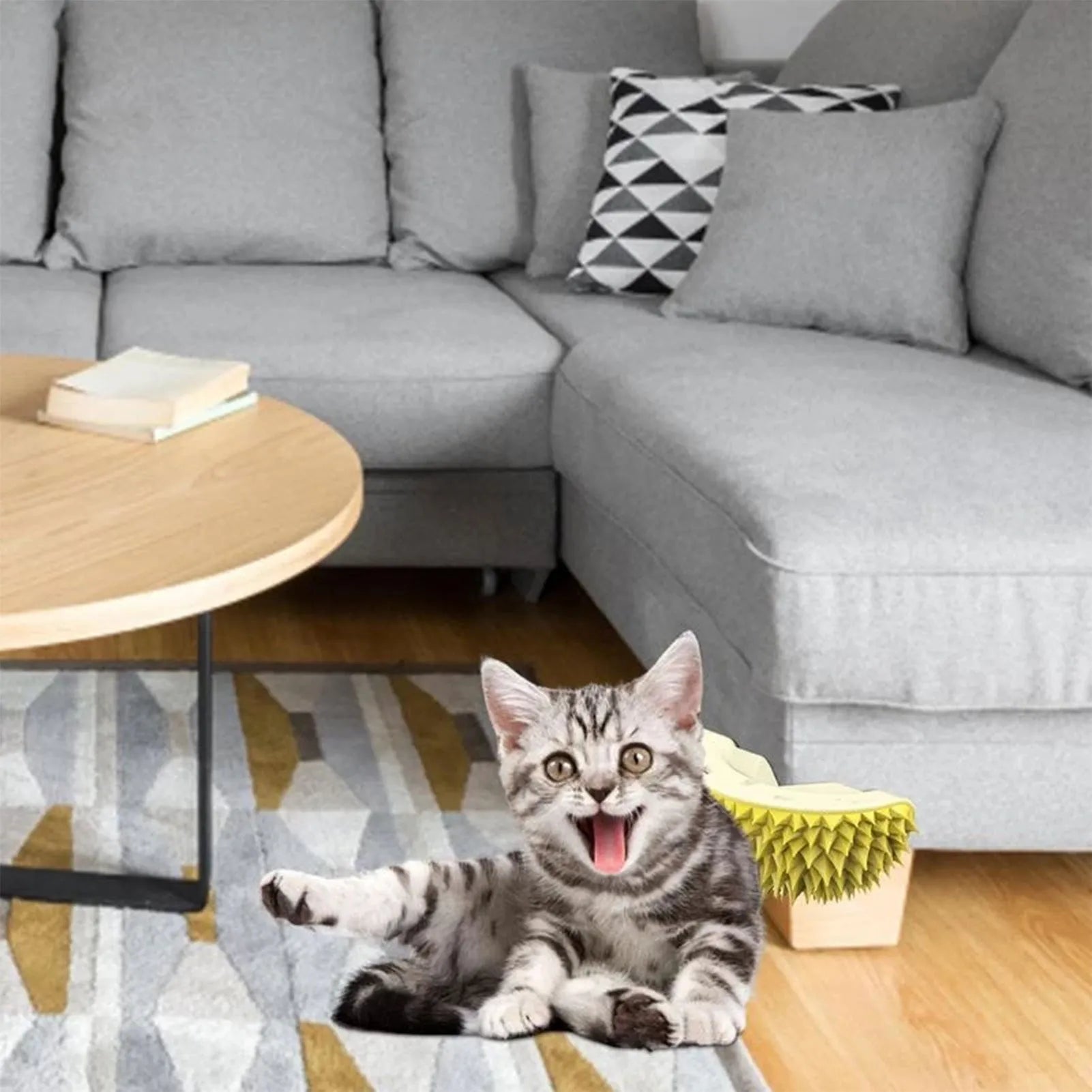 Durian-shaped cat tickling brush toy in green mounted on wall with rotating catnip ball
