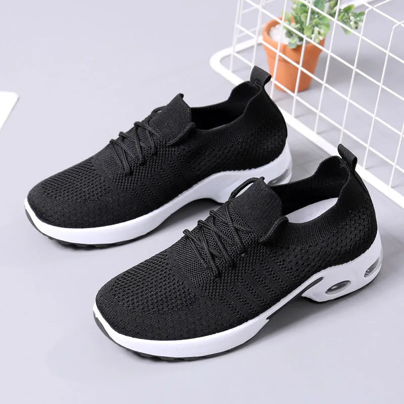 Women's black mesh casual sneakers with lace-up front and a light grey PVC sole.