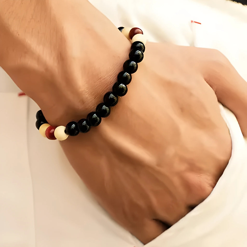 Natural stone beaded bracelet with lava stone beads on wrist, showing ethnic design and essential oil application