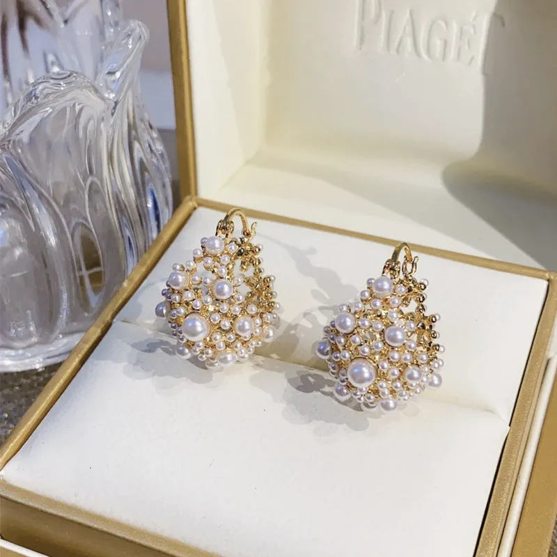 Gold women's flower basket earrings with pearl bead decoration on copper