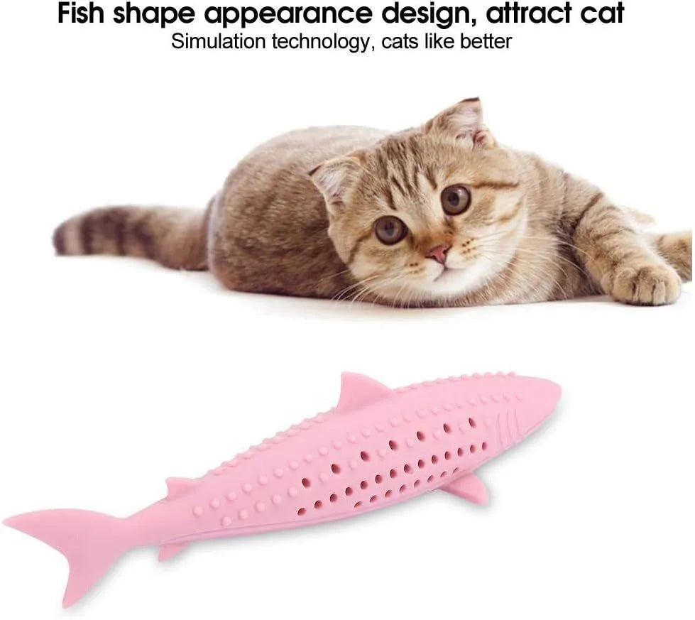 Green silicone fish-shaped cat chew toy with breathable side holes on wooden floor