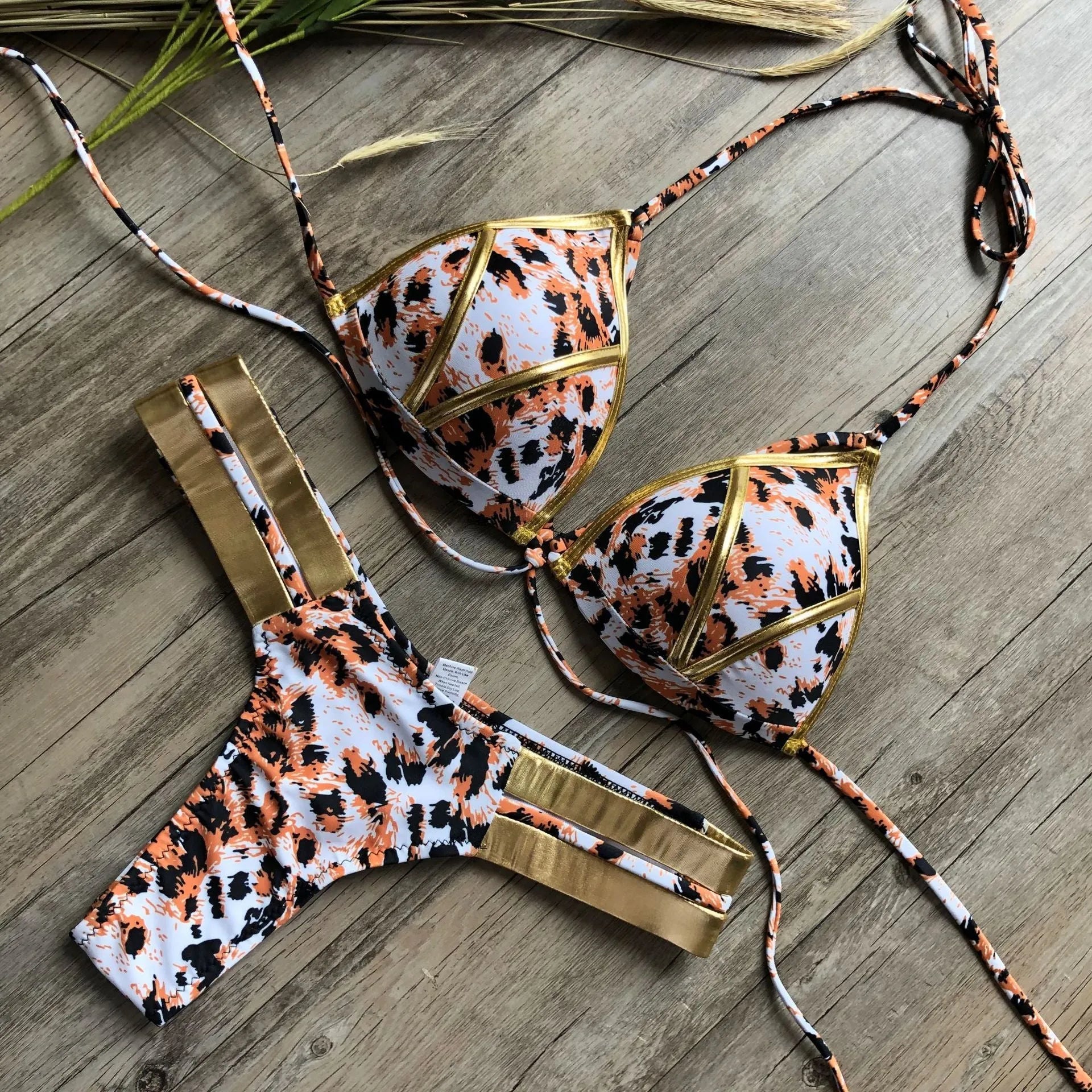 Women's bronzing bikini swimwear with chest pads in various colours and prints.