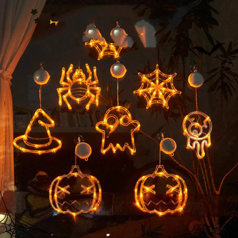 Seven Halloween LED lights with suction cups featuring spider, pumpkin and ghost designs for window decoration
