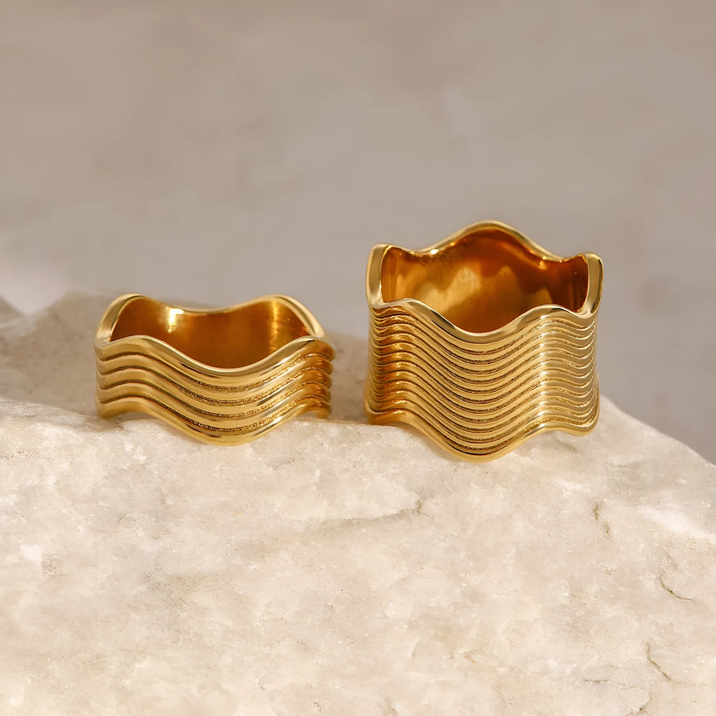 Stainless steel geometric wave ring for women with a wide surface area and electroplated finish.