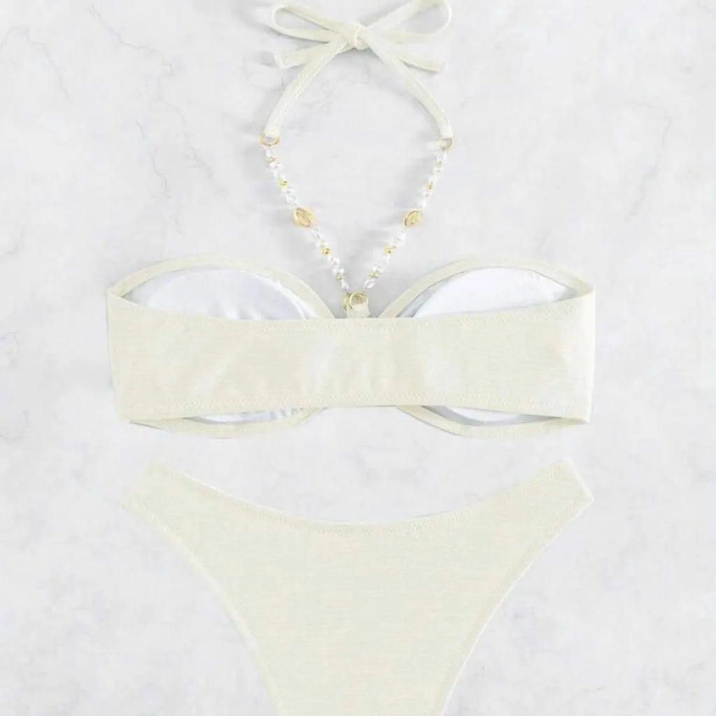 Women's creamy-white halter top and briefs bikini set for swimming on a beach