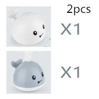 Electric whale-shaped baby bath toy with water spray, LED lights, and automatic water sensor