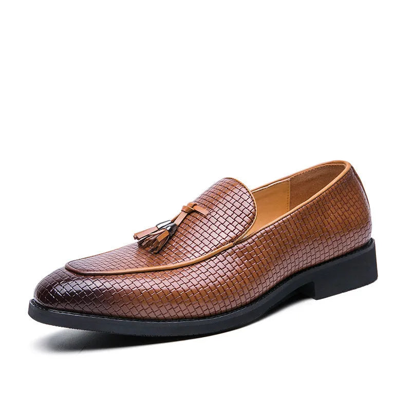 Men's black pointed toe slip on shoes with a gold tassel detail on the upper.
