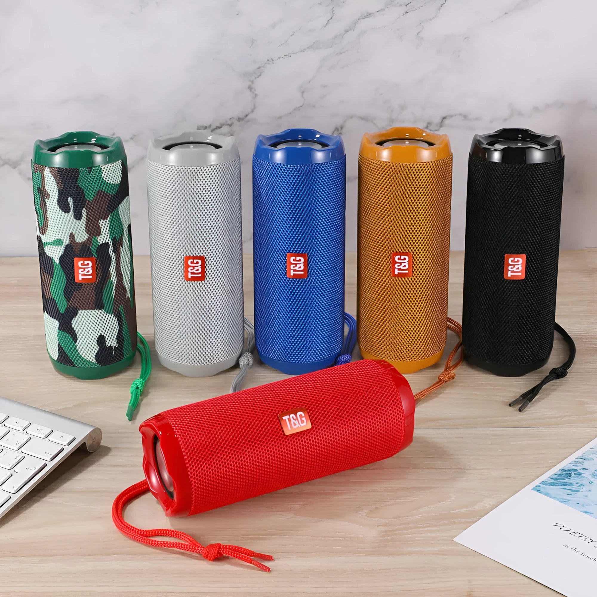 Fabric-covered portable Bluetooth speaker in multiple colours showing card holder slot.