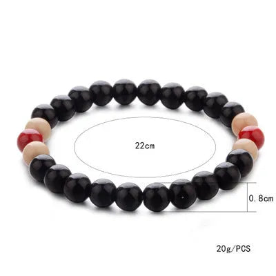 Natural stone beaded bracelet with lava stone beads on wrist, showing ethnic design and essential oil application