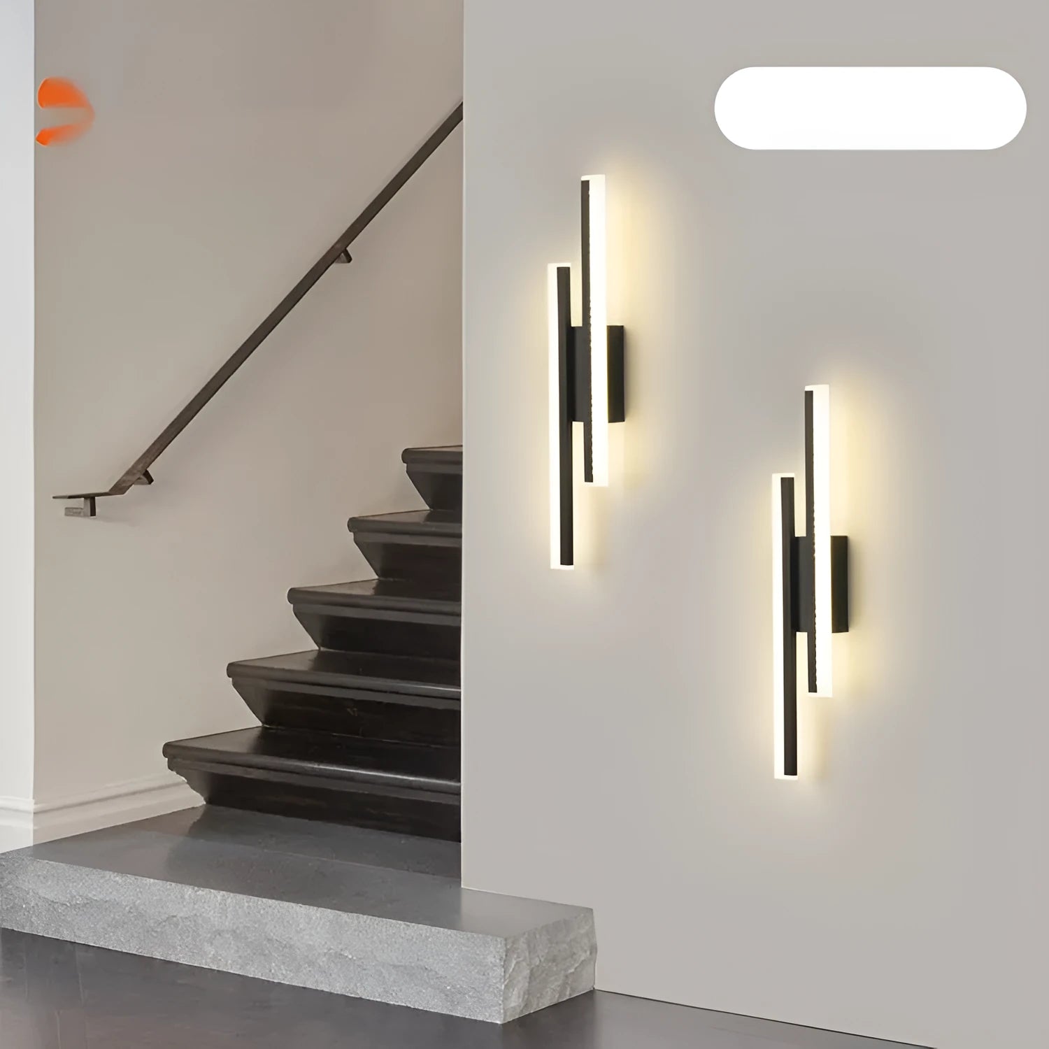 Gold-finish 500mm long double line wall lamp with LED light on a modern wall.