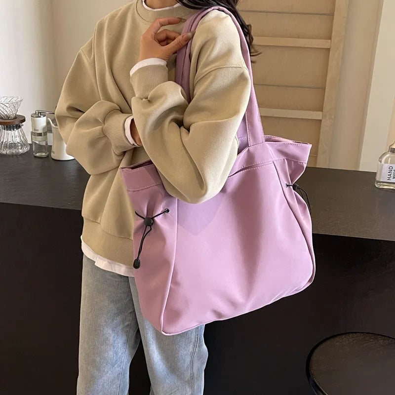 Soft Oxford cloth commuter tote bag in a street style, shown in a folded position.