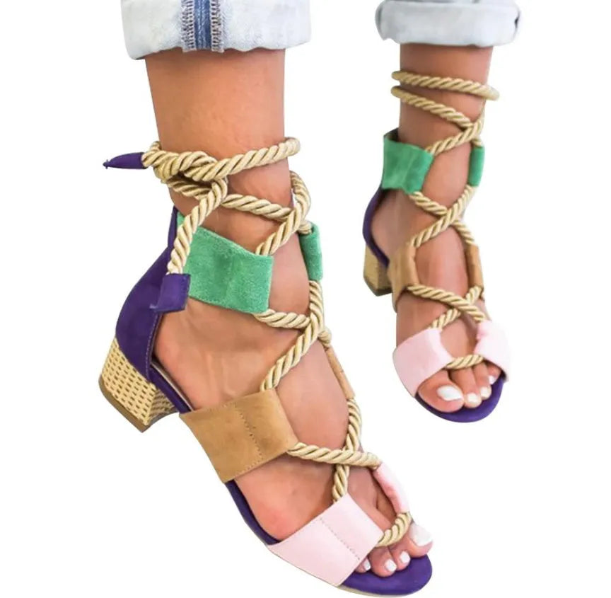 Women's beige suede sandals with thick mid-heel, front strap, and ankle strap on a plain background.