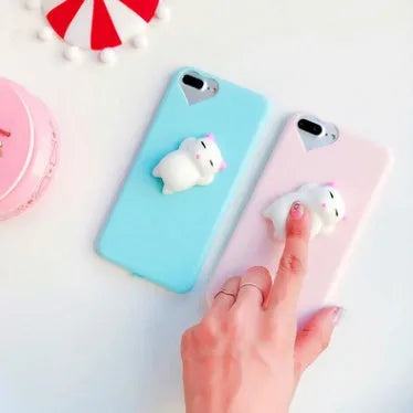 Soft silicone TPU iPhone case with a raised 3D cartoon cat design, shown in various colours.
