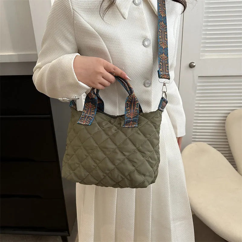 Soft horizontal square Oxford cloth shoulder messenger bag in green with embroidery detail and a single strap.