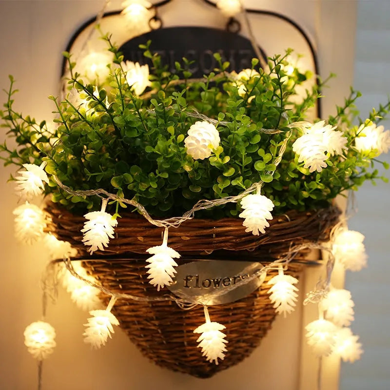 Battery-powered LED pine cone light string in warm white with plastic pine cone shells