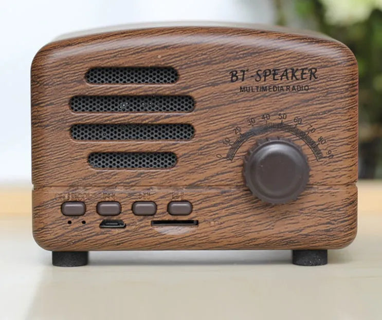 Wood grain finish bluetooth speaker showing compact design with USB charging port