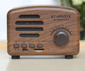 Wood grain finish bluetooth speaker showing compact design with USB charging port
