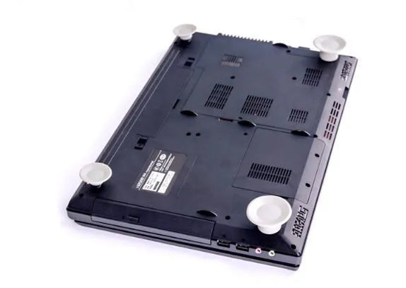 Set of four grey plastic laptop cooling pads: two large and two small, on a desk.