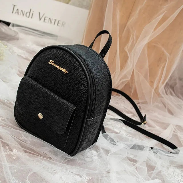 Women's black PU backpack purse with letter design and shoulder strap showing compact 18.5cm length