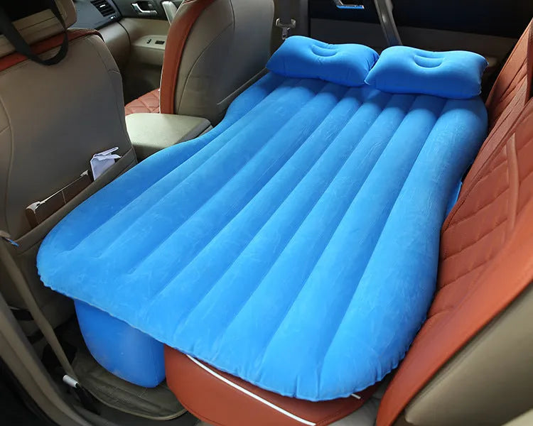 Black inflatable car bed with flocking surface and two pillows, shown folded next to a storage bag.