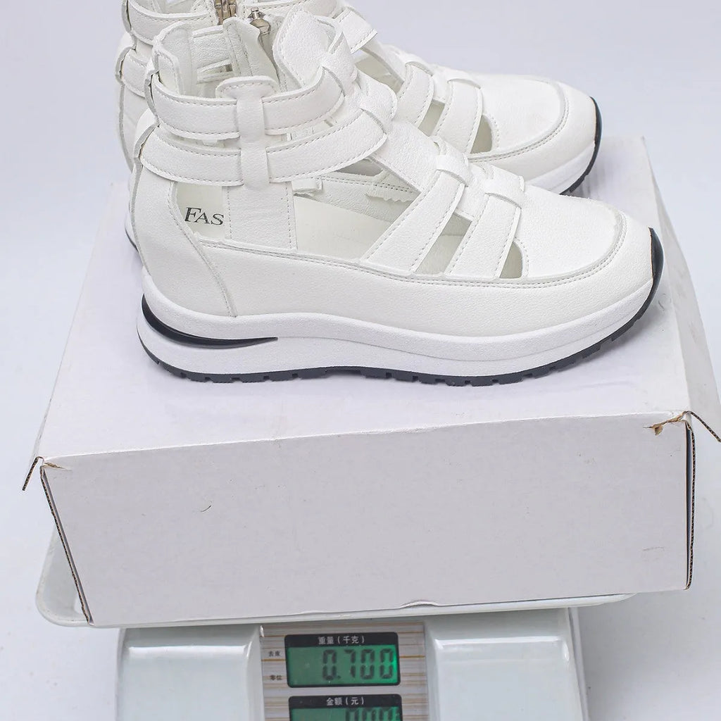 Women's black close-toed platform sandals with Velcro strap and hollow-out design.