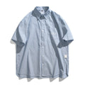 Blue and white striped loose-fitting short-sleeve cardigan shirt on a hanger