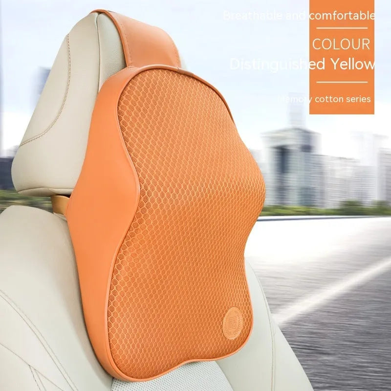 Black and brown memory foam car headrest and lumbar support pillows on a car seat.