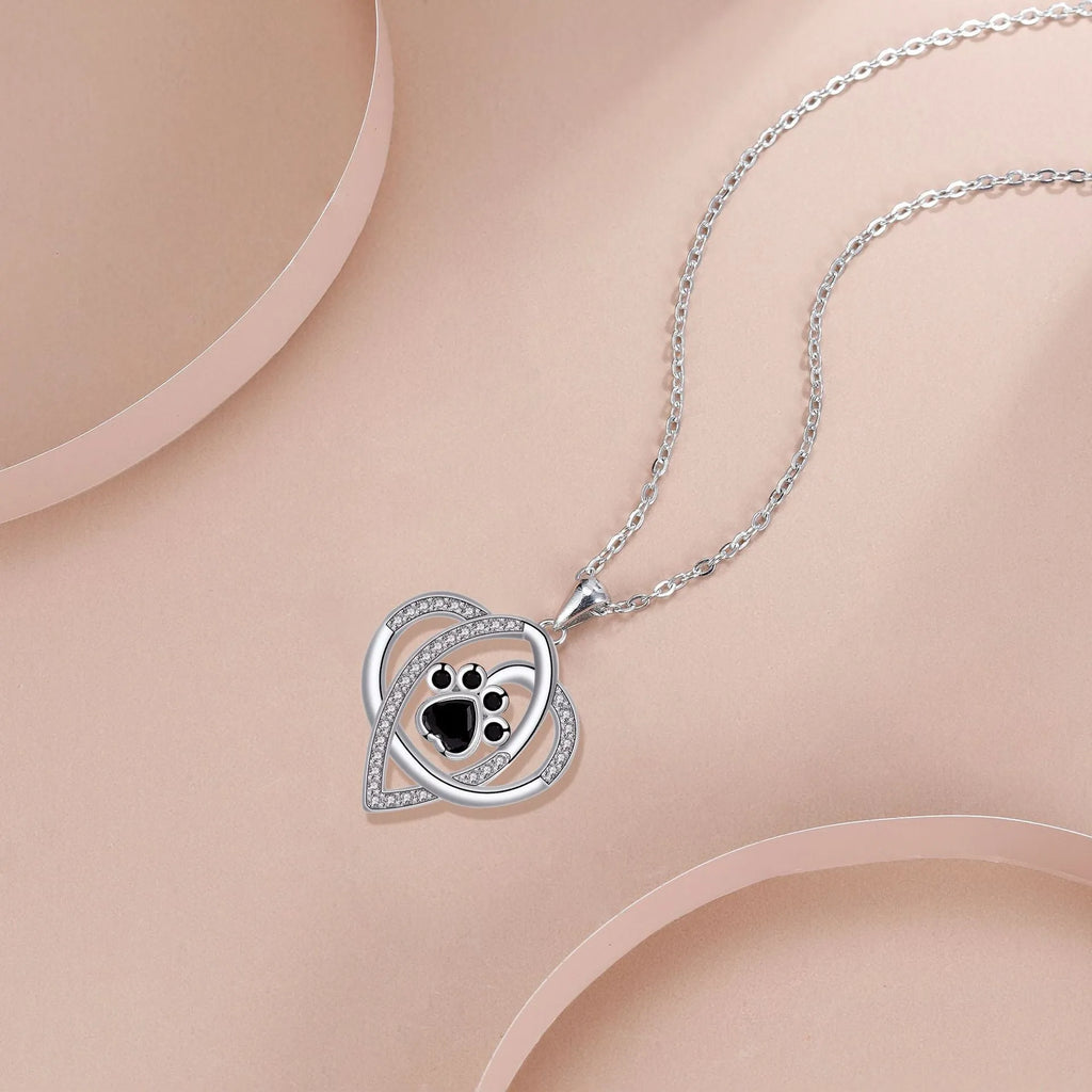 Copper pendant necklace with dog and cat paw print design on a cross chain