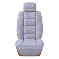 Short plush car seat cushion in charcoal grey on vehicle seat