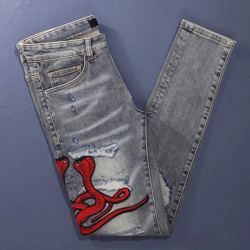 Men's slim fit old colour jeans with hole patch detail and embroidered branding on the leg