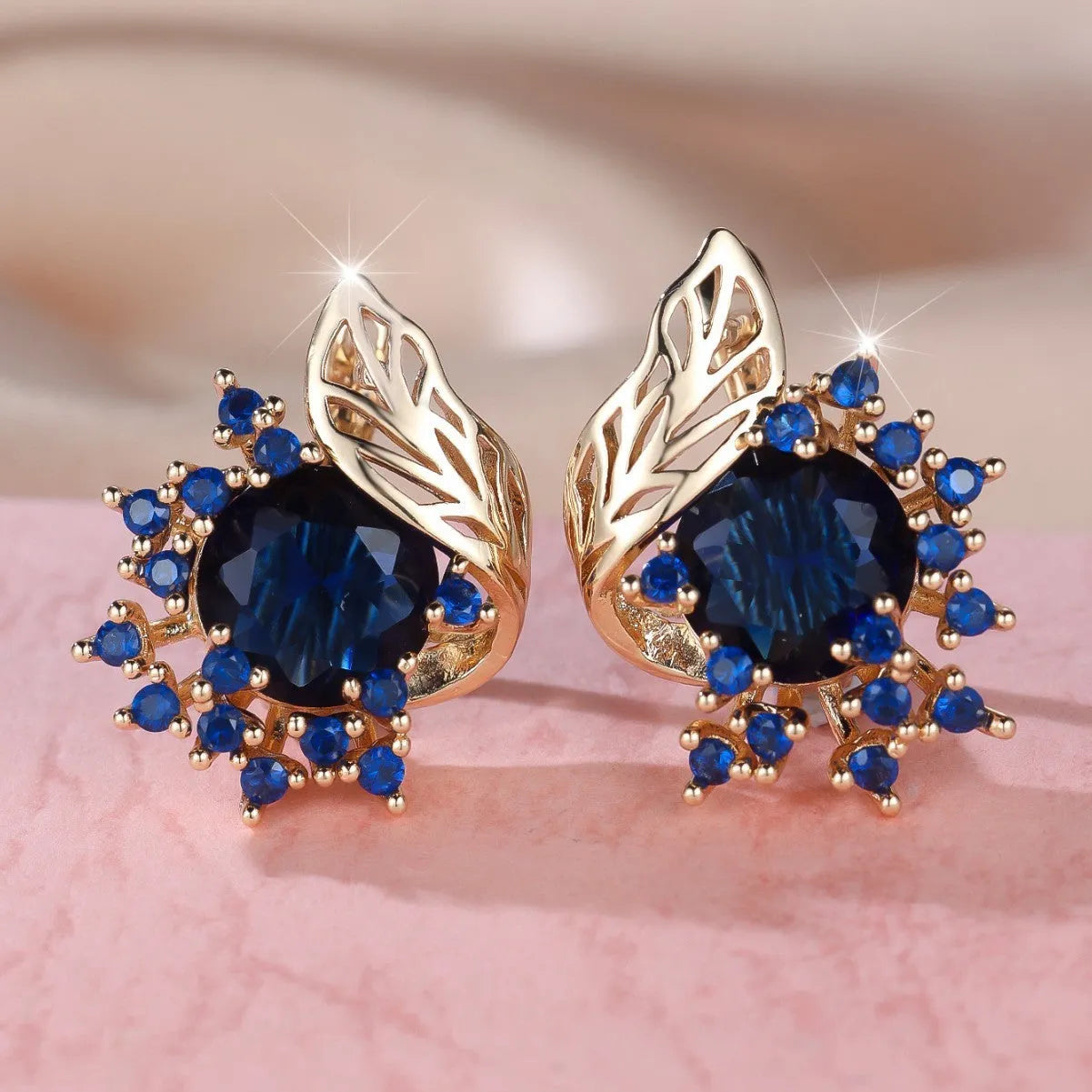 Round floral earrings with feather detailing and coloured zircon stones in champagne gold finish