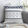 Bohemian patterned pillow cover in light gray on a living room sofa with decorative throw