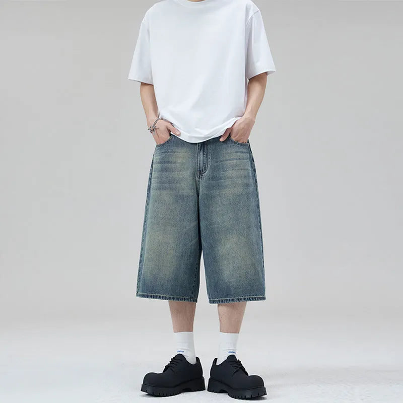 Men's straight-leg cotton denim shorts in cropped length on a casual model
