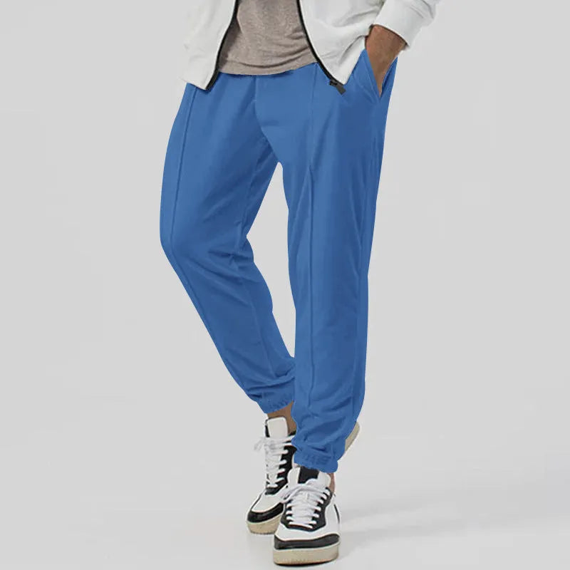 Men's loose tapered casual sweatpants in a grey cotton blend fabric with an elastic waistband.