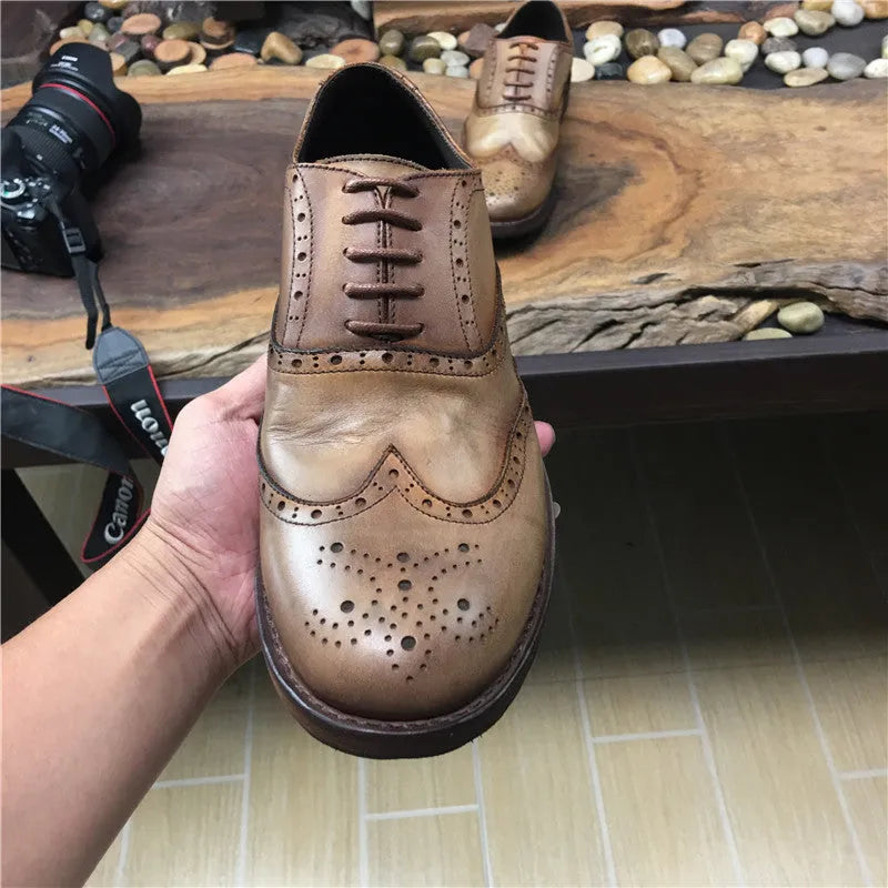 Men's light brown vintage distressed leather casual shoes with engraved detailing and round toe.