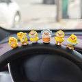 Set of six small cartoon duckling figures and one hello sign for car dashboard decoration.