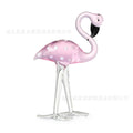 Pink crystal flamingo decorative sculpture on table with modern minimalist design