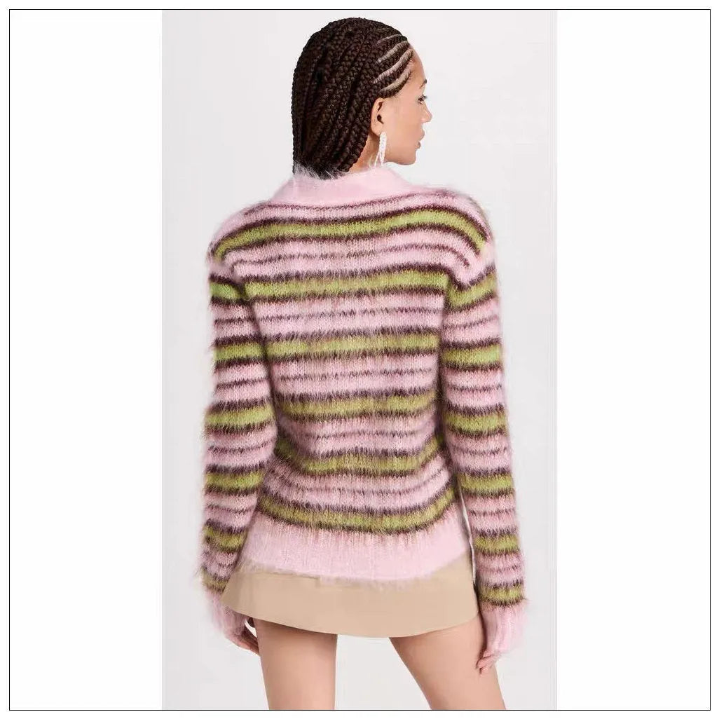 Pink women's wool knitted cardigan and round-neck pullover sweater with contrast details on a hanger.