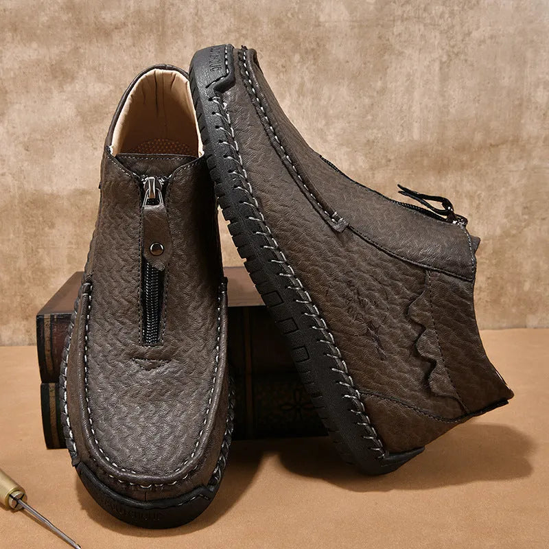 Men's black slip-on leather loafers with a round toe and rubber sole on a white background.